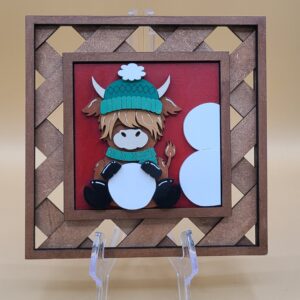 Highland sitting with snowball